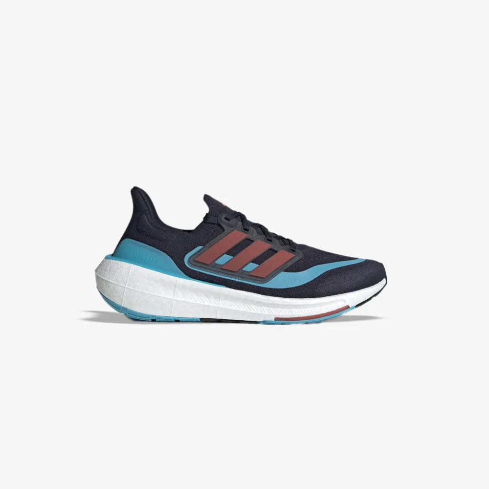 کفش دویدن اورجینال برند Adidas مدل Ultraboost Light رنگ سرمه ای و آبی نمای بغل